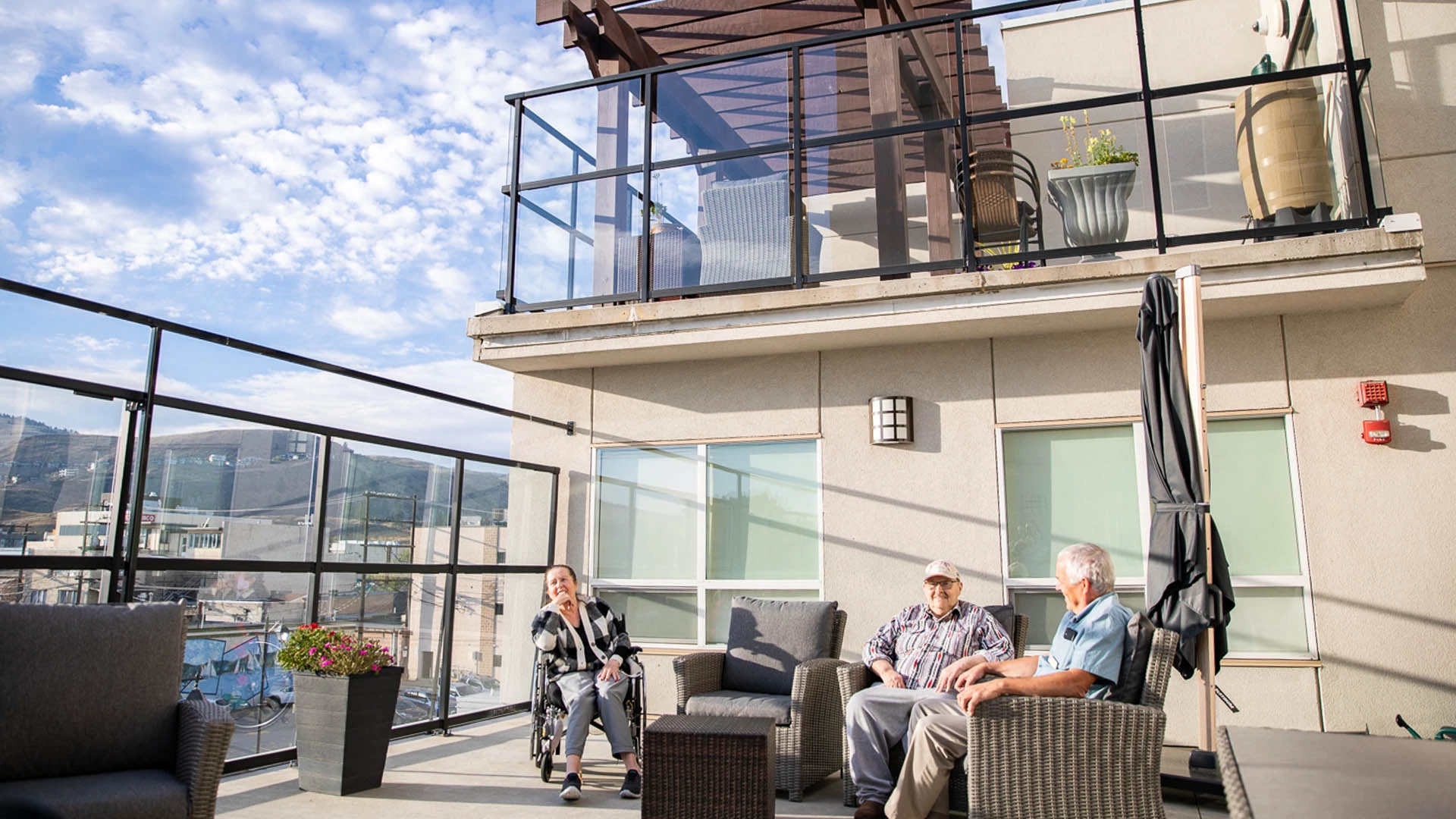 Senior Citizens sitting outside the building under sunlight