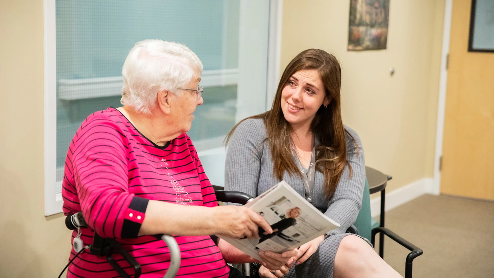 Staff member talking with a female senior